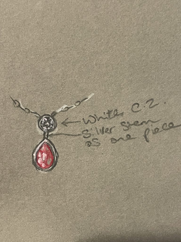 A garnet pendant necklace designed by Aimi